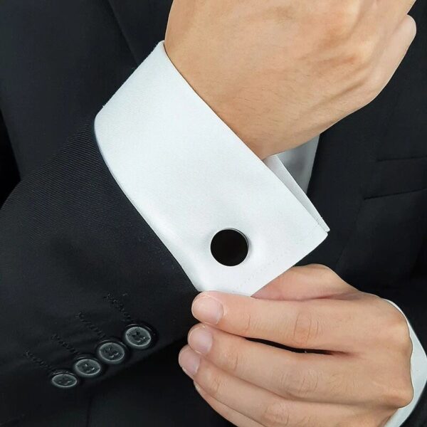 Black cufflink on sleeve